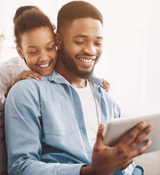 Father and daughter having video call on tablet